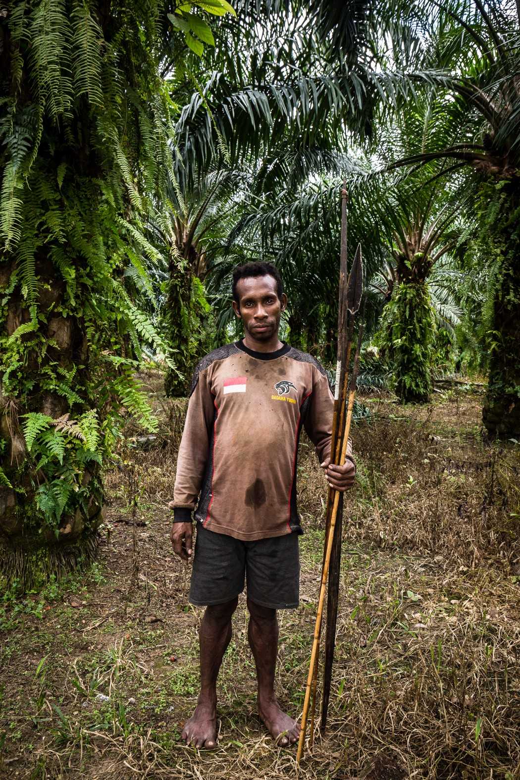 Tadius Butipo, 30, works in an oil palm plantation in southern Papua. By Albertus Vembrianto for The Gecko Project/Mongabay.