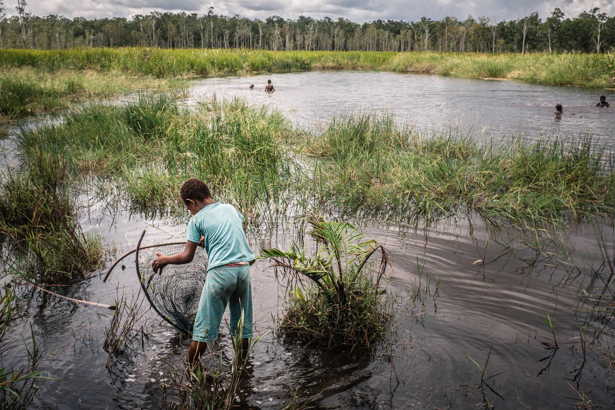 Photo of children playing in a swamp near Zanegi. They also often fish here. 